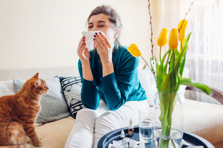 Spring allergies and woman sneezing